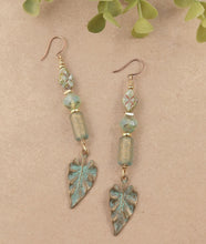 Load image into Gallery viewer, Etched Patina Face Charm and Leaf Dangling Earrings