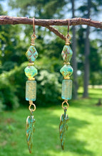 Load image into Gallery viewer, Etched Patina Face Charm and Leaf Dangling Earrings